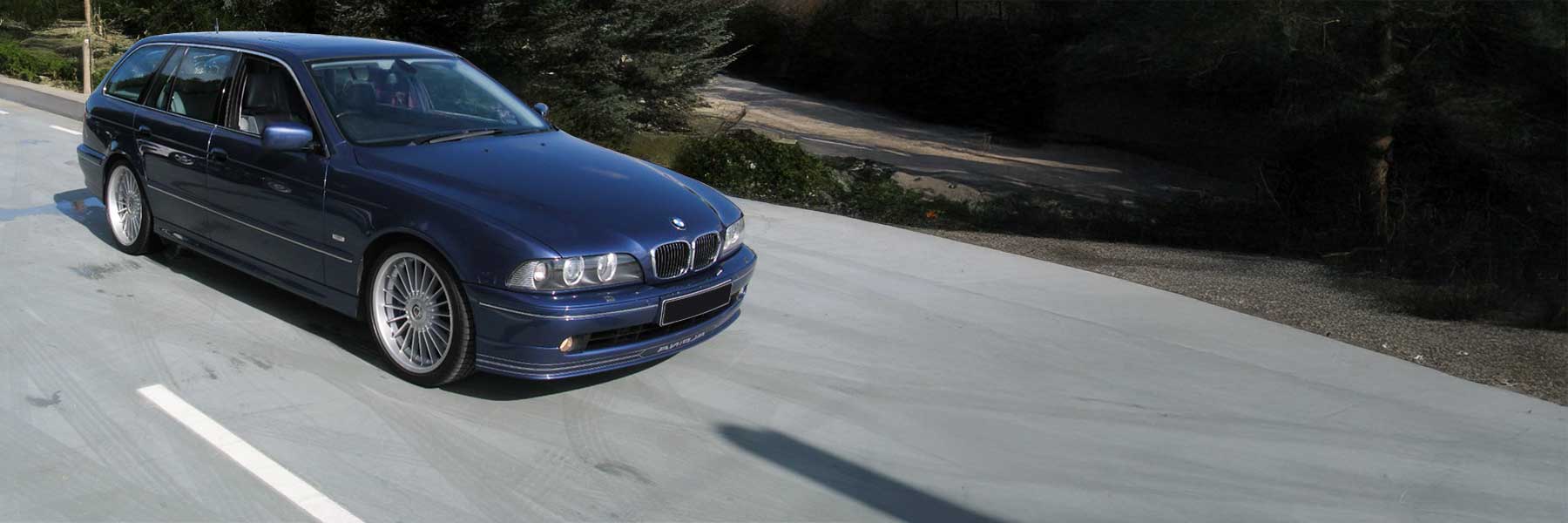 Banner image of a  Alpina B10 E39 featuring original Alpina wheels.