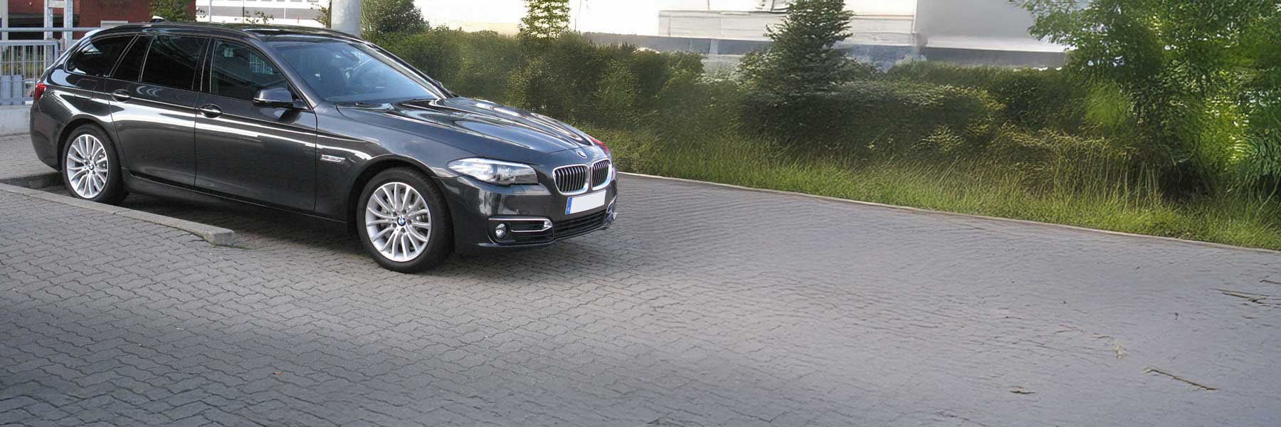 Banner image of a  BMW 5 Series F11 featuring original BMW wheels.