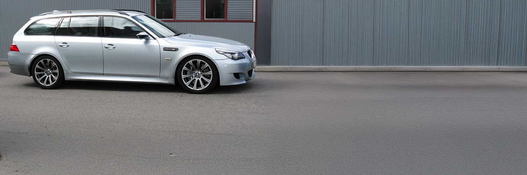 Banner image of a  BMW M5 E61 featuring original BMW wheels.