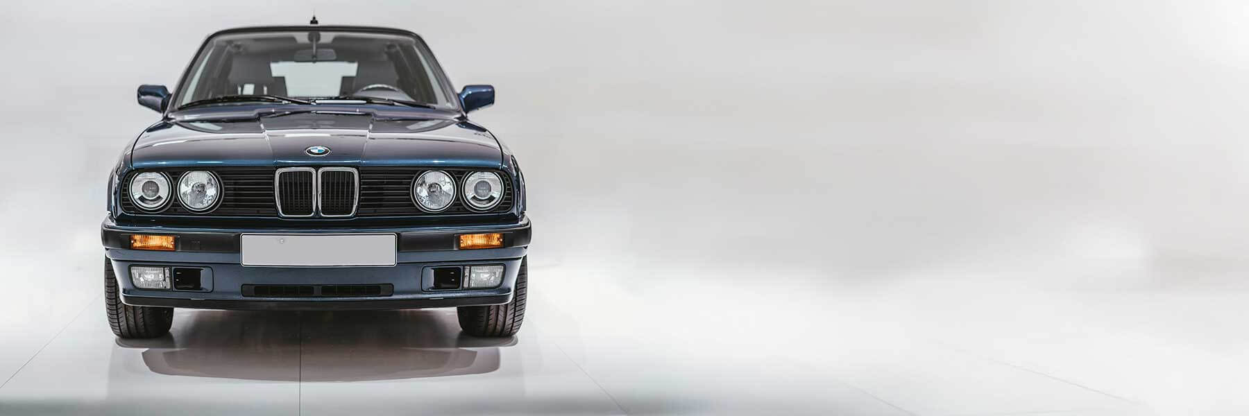 Banner image of a  BMW 3 Series E30 featuring original BMW wheels.
