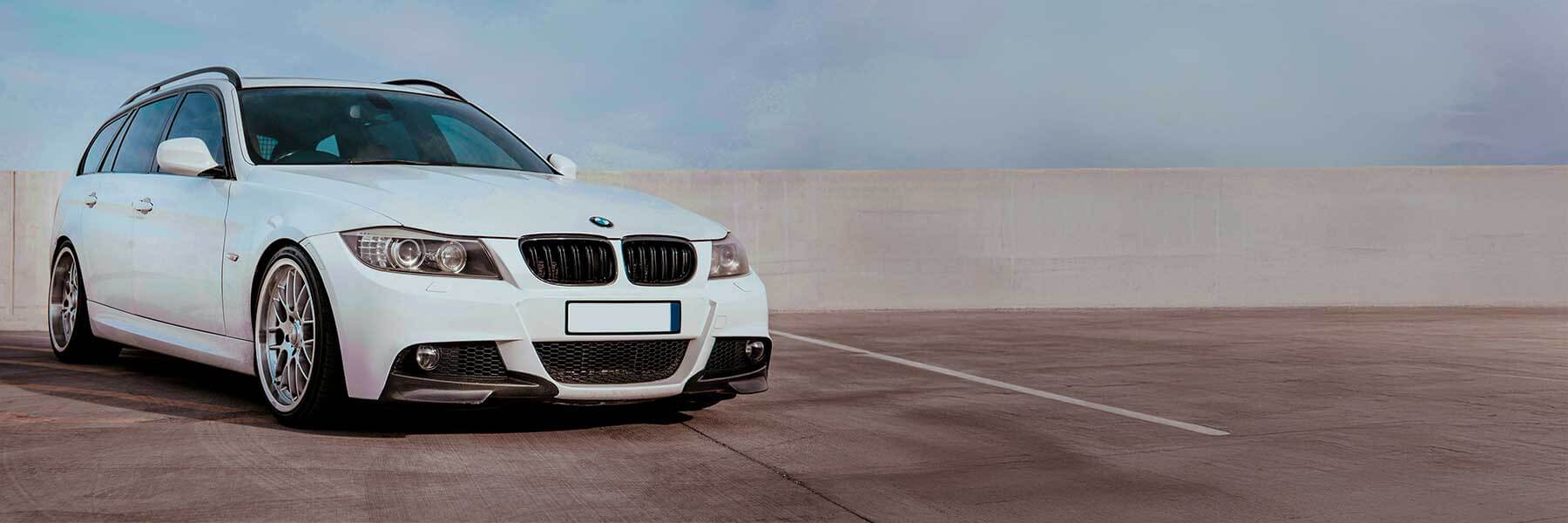 Banner image of a  BMW 3 Series E91 featuring original BMW wheels.