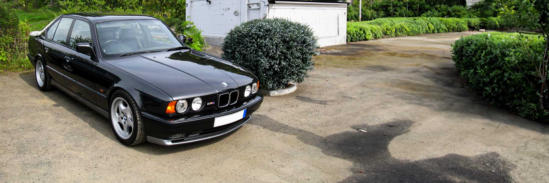 Banner image of a  BMW 5 Series E34 featuring original BMW wheels.