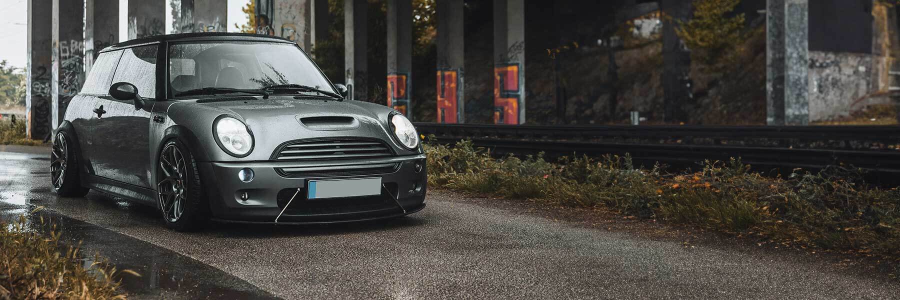 Banner image of a  MINI Hatchback R53 featuring original MINI wheels.