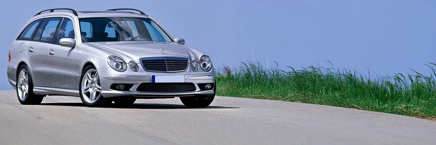 Banner image of a  Mercedes E-Class S211 featuring original Mercedes wheels.