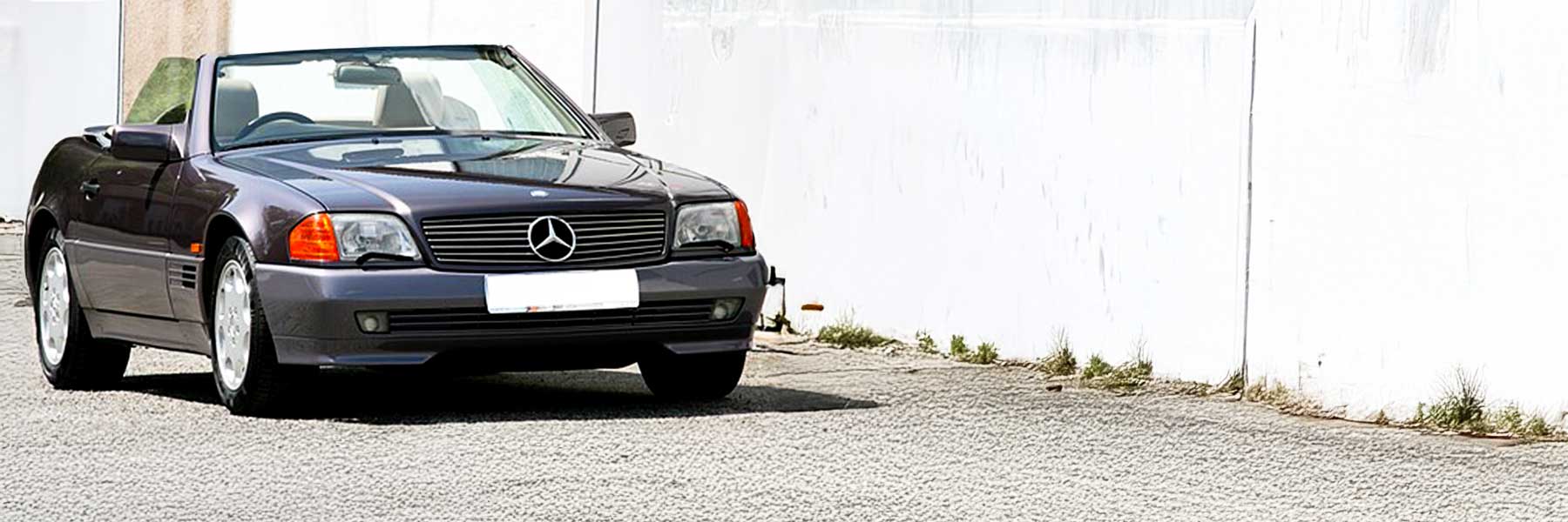 Banner image of a  Mercedes SL R129 featuring original Mercedes wheels.