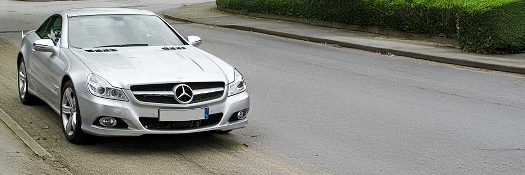Banner image of a  Mercedes SL R230 featuring original Mercedes wheels.
