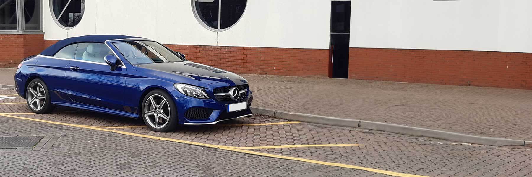 Banner image of a  Mercedes C-Class A205 featuring original Mercedes wheels.