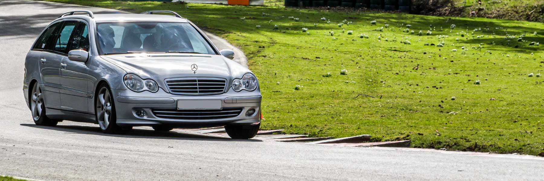 Banner image of a  Mercedes C-Class S203 featuring original Mercedes wheels.