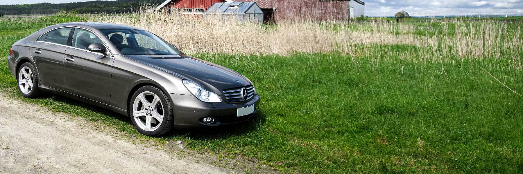 Banner image of a  Mercedes CLS C219 featuring original Mercedes wheels.