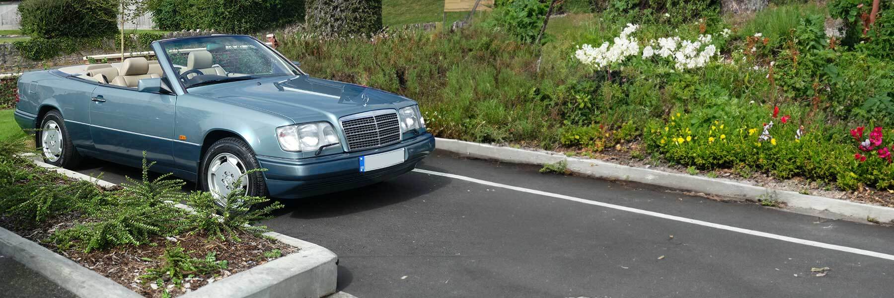 Banner image of a  Mercedes E-Class A124 featuring original Mercedes wheels.