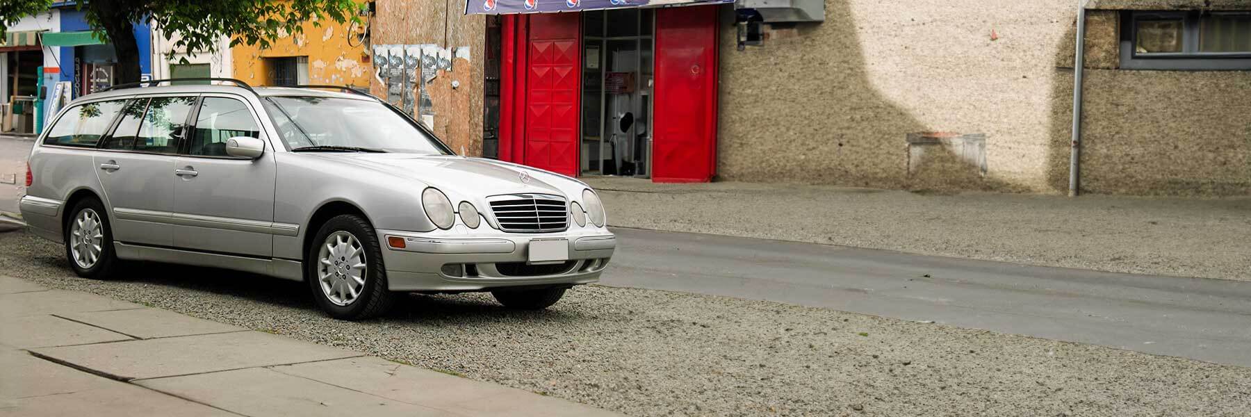 Banner image of a  Mercedes E-Class S210 featuring original Mercedes wheels.