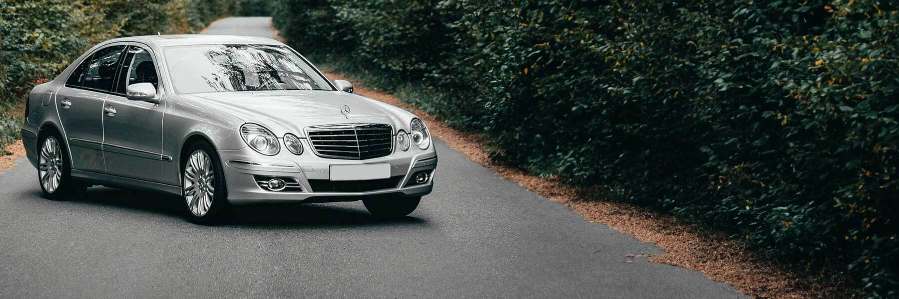 Banner image of a  Mercedes E-Class V211 featuring original Mercedes wheels.