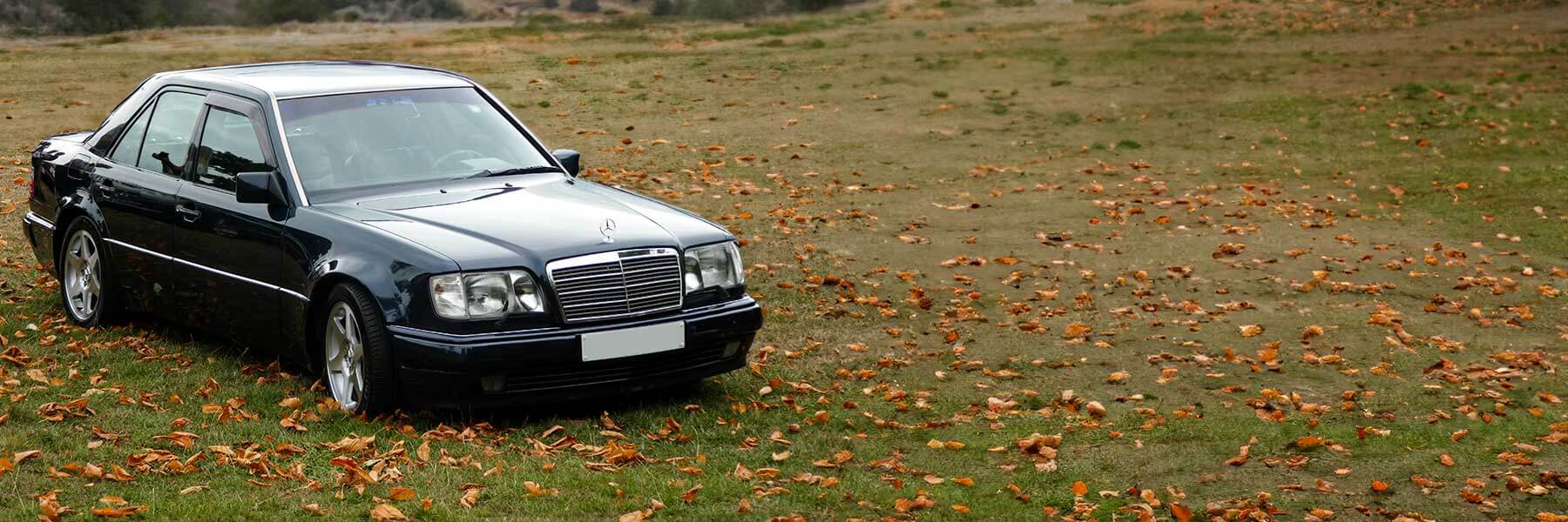 Banner image of a  Mercedes E-Class W124 featuring original Mercedes wheels.