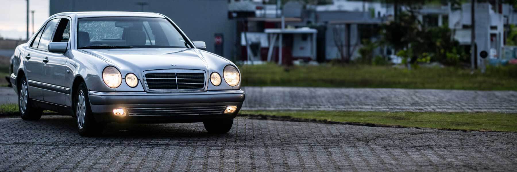 Banner image of a  Mercedes E-Class W210 featuring original Mercedes wheels.