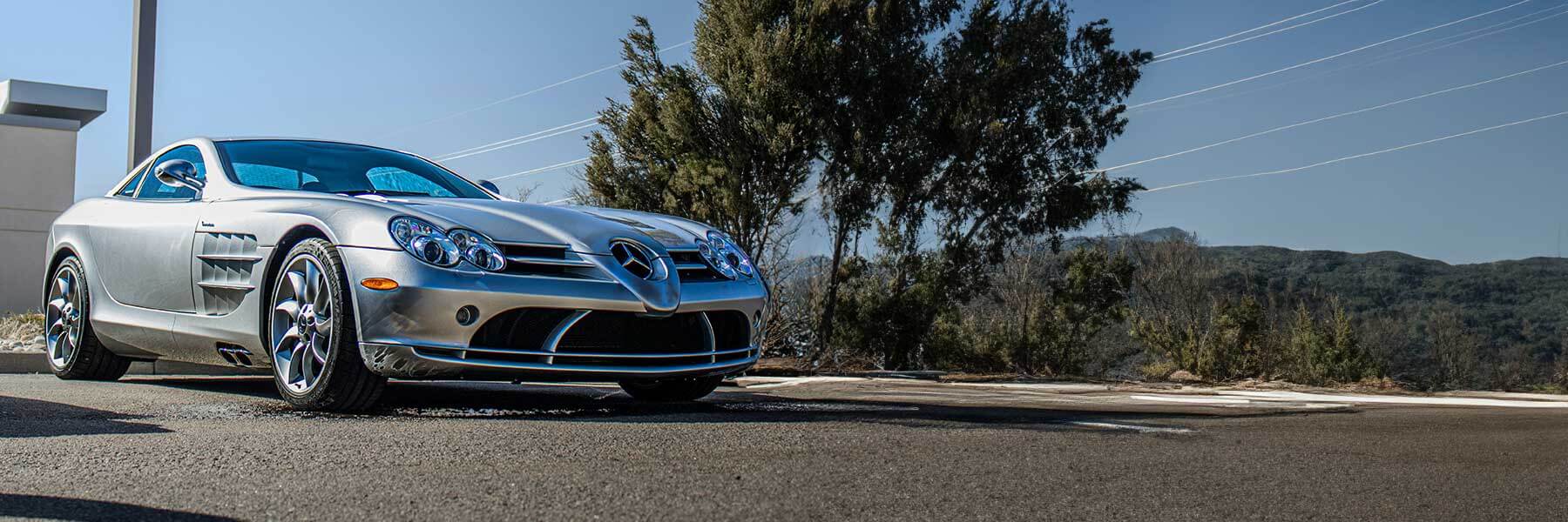 Banner image of a  Mercedes SLR C199 featuring original Mercedes wheels.