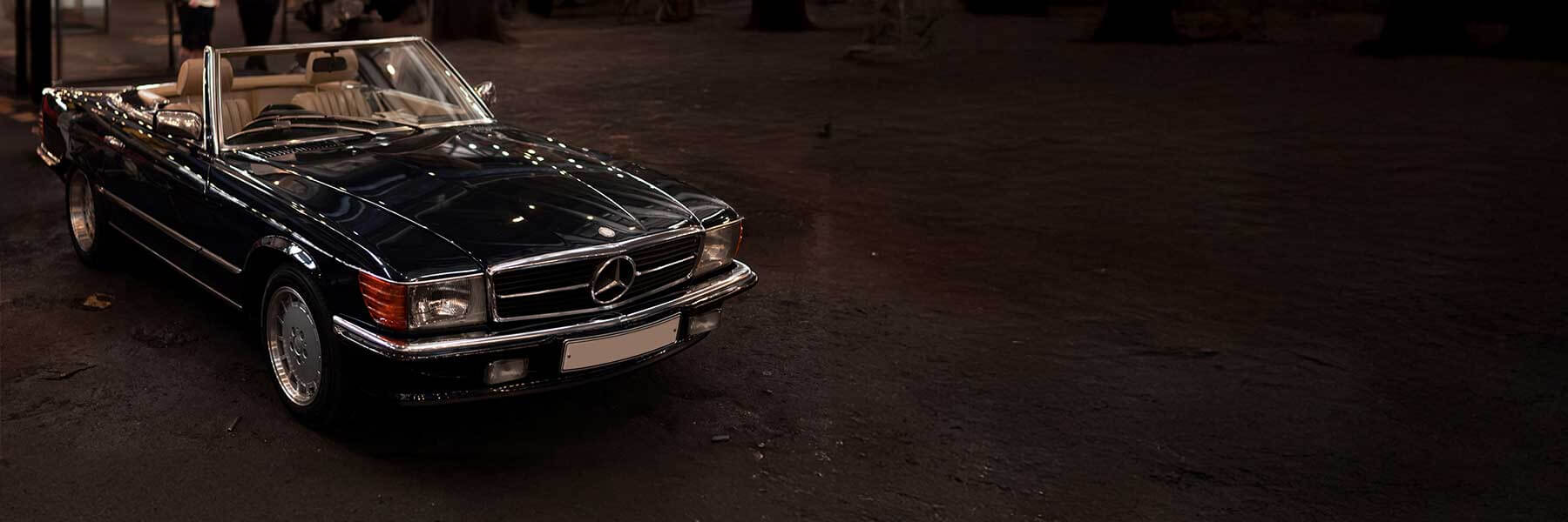 Banner image of a  Mercedes SL C107 featuring original Mercedes wheels.