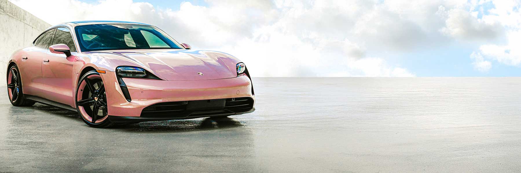 Banner image of a  Porsche Taycan J1 featuring original Porsche wheels.