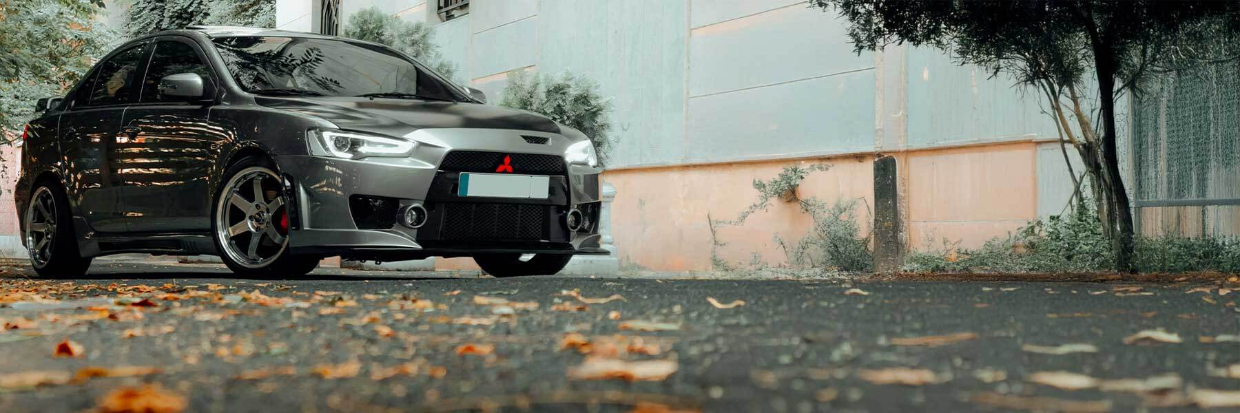 Featured banner showcasing the Mitsubishi Eclipse with original Mitsubishi wheels.
