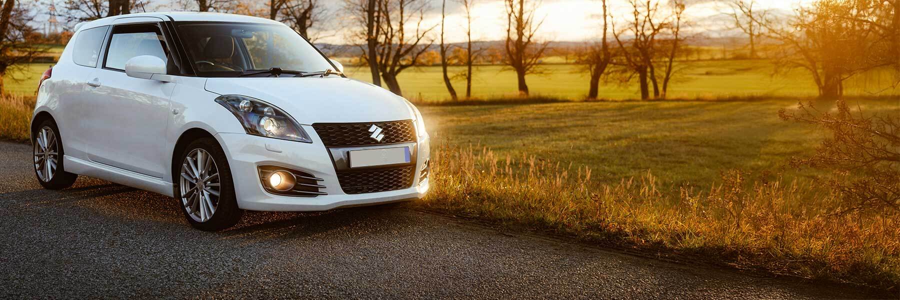 Banner image of a  Suzuki SX4 EY/GY featuring original Suzuki wheels.