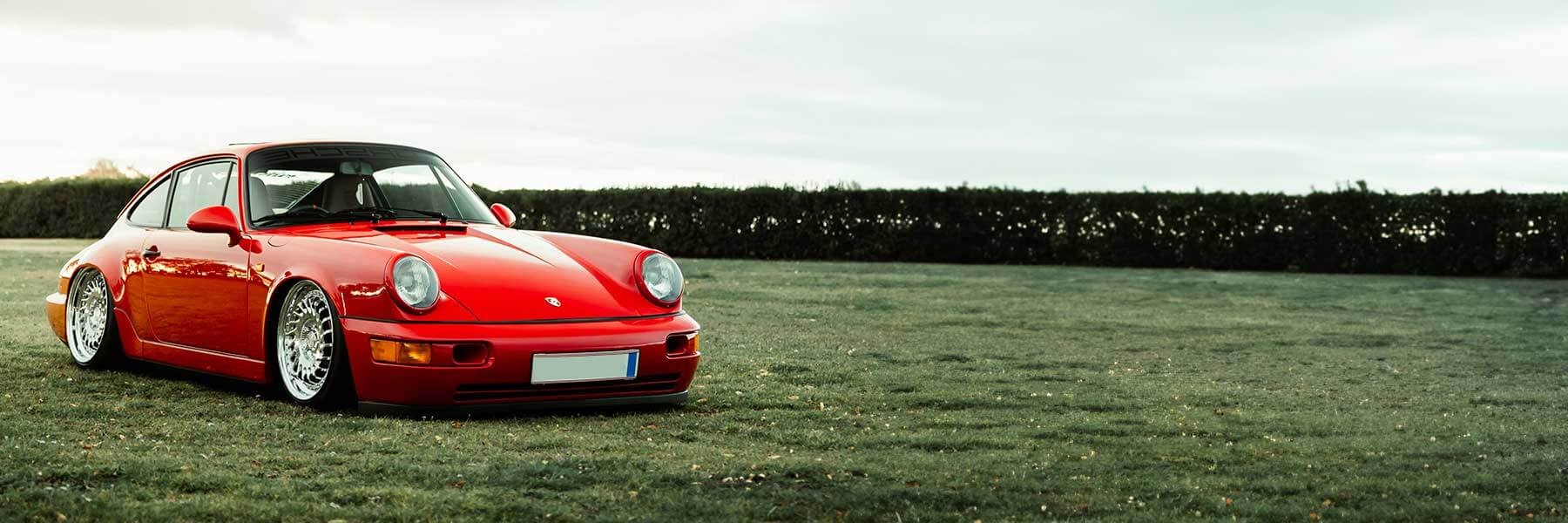 Featured banner showcasing the Porsche 964 (911) with original Porsche wheels.