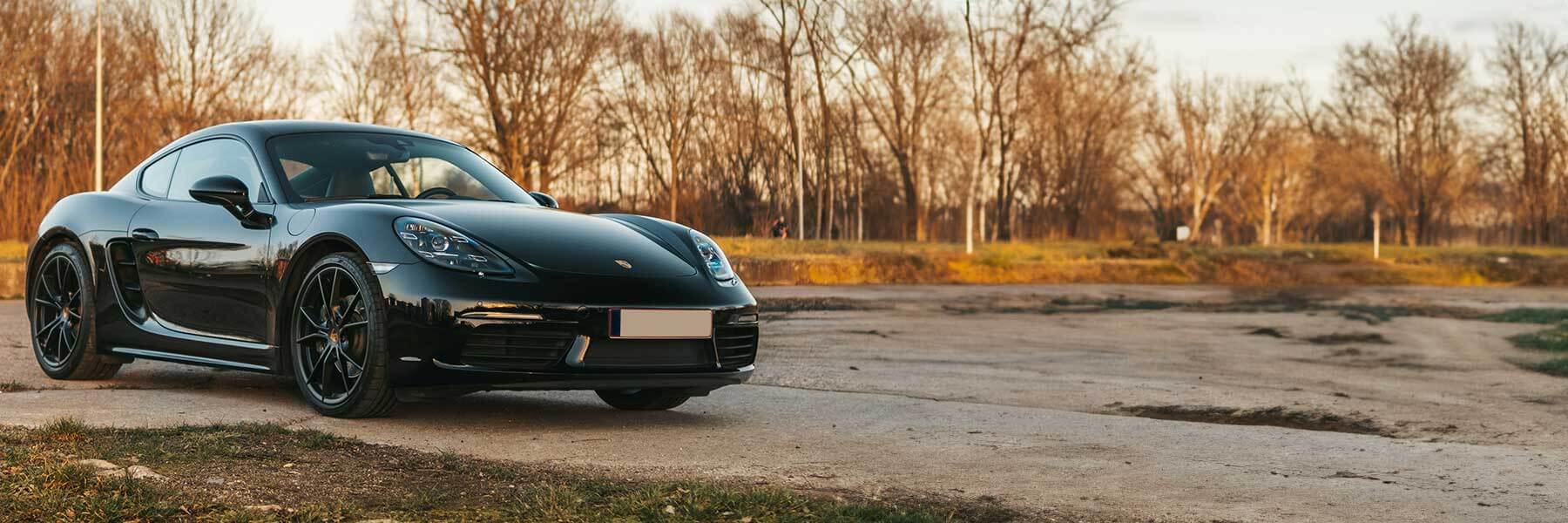 Featured banner showcasing the Porsche Cayman with original Porsche wheels.